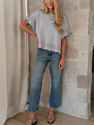 Light blue knit top with crew neck, short sleeves and delicate lace trim.