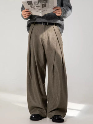 Men's brown wide-leg trousers with pleats and a relaxed fit.