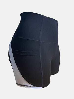 Colorblock pocketed sculpt shorts in black with a white side stripe detail.