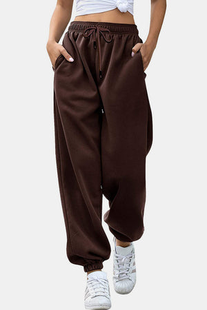 Relaxed-fit cuffed sweatpants in chocolate brown with drawstring waist and pockets.