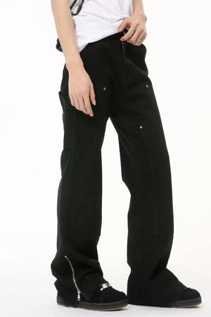 Black bootcut denim pants with zip hem detail and utility pockets