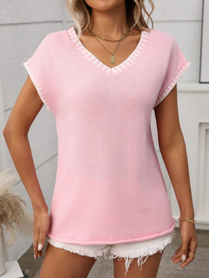Blush pink knit V-neck sweater top with white contrast trim on neckline and sleeves.