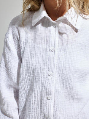 Textured white cotton overshirt with relaxed fit and button front detail