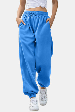 Blue slouchy sweatpants with gathered cuffs and drawstring waist.