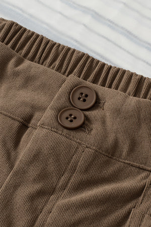 Caramel seamed front wide leg trousers with elastic waistband and two button details.