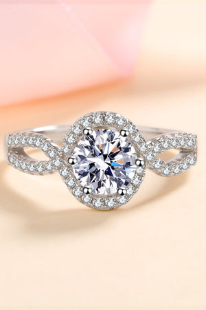 Silver moissanite engagement ring with halo and infinity band.