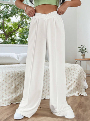 White V-waistline palazzo sweatpants with center seams and wide legs.