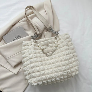 Textured grid pearl chain tote in ivory with a bubble pattern and chain detail.