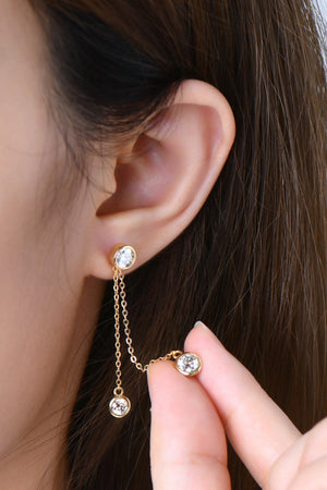 Gold cascade diamond drop earrings with chain detail and bezel-set stones.