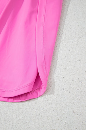 Scoop neck active romper set in fuchsia pink with side slits and clean stitching detail.