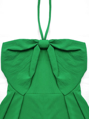 Green halterneck romper with large bow detail and smocked back.