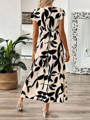 Floral print midi dress in black and apricot with cap sleeves and a-line cut.