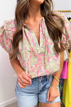 Ruffled floral print v-neck shirt with tie detail and puff sleeves.