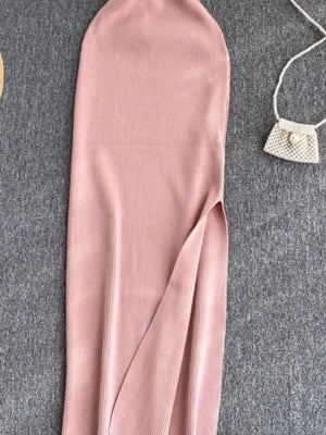 Pink ribbed knit midi dress with a high slit and a cutout detail.