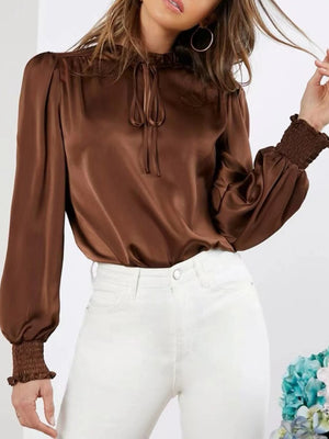 Brown satin tie-neck blouse with shirred cuffs and puff sleeves