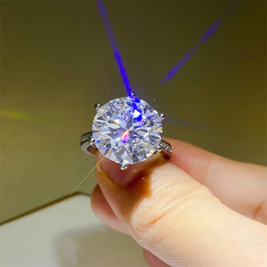 Silver solitaire ring with a large, round-cut diamond and smaller stones on the band.