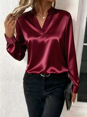 Wine red satin maternity blouse with notched V-neck and buttoned cuffs.