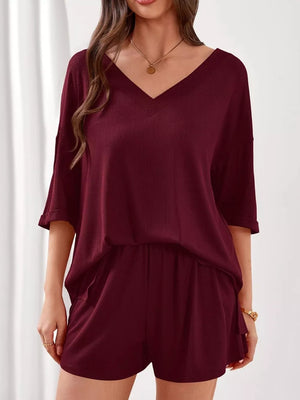 Burgundy V-neck ribbed two-piece loungewear set with cuffed sleeves and elastic waist shorts.