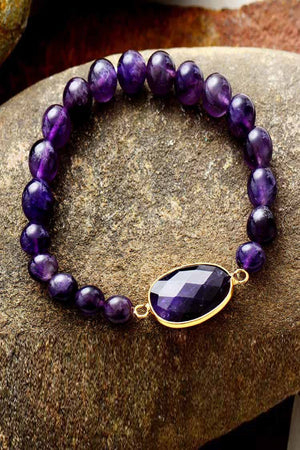 Amethyst beaded bracelet with faceted oval stone and gold accents