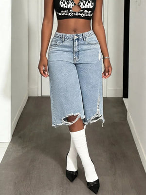 Distressed light wash denim wide-leg shorts with raw, ripped hems and pockets.