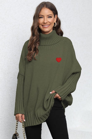 Army green batwing knit turtleneck sweater with red heart embroidery and ribbed details.