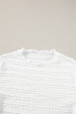 White textured long sleeve top with ruffle trim neckline and smocked fabric detail