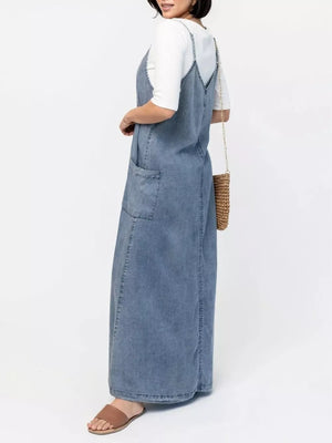 Light blue denim maxi dress with V-neck, spaghetti straps, and front pockets.