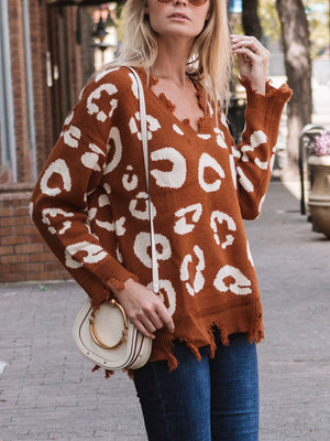 Brown leopard print knit sweater with distressed raw edges and V-neck.