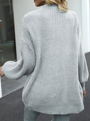 Gray chunky knit cocoon cardigan with balloon sleeves and ribbed texture.