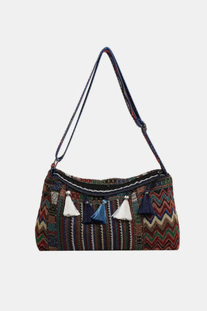 Geometric embroidered shoulder bag with tassels and a colorful chevron pattern.
