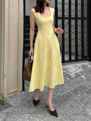 Sleeveless yellow a-line midi dress with a square neckline and subtle vertical seams.