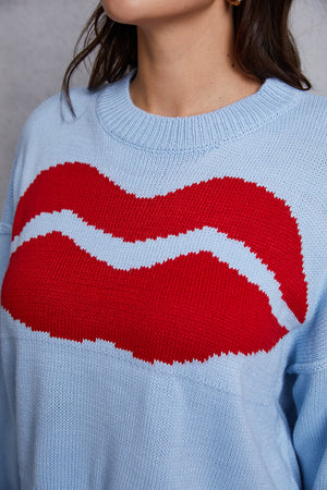 Light blue acrylic knit sweater with a large red kiss graphic and distressed hem.