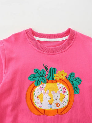 Pink cotton crew neck sweatshirt with pumpkin applique featuring two bunnies drinking from mugs.