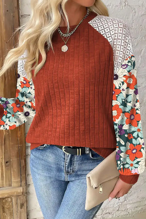Terracotta ribbed knit top with floral print sleeves and lace shoulder detail.