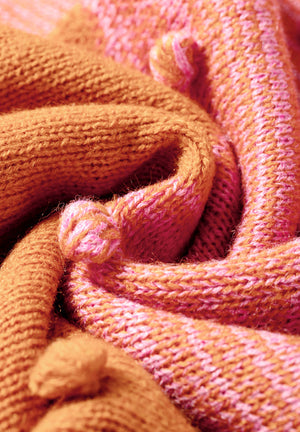 Textured acrylic bobble cardigan in pink and caramel colorblock with a ribbed knit.