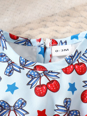 Baby one-piece with cherry and bow print, blue with red accents, cotton fabric.