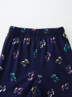 Navy cotton toddler sleepwear pants with colorful unicorn print and elastic waistband.