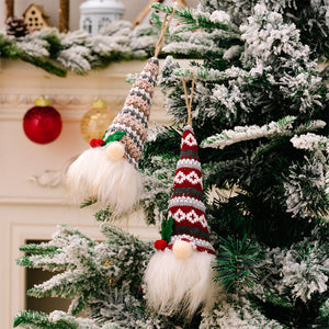 Illuminated gnome ornaments in Style A and Style B, with knitted hats and white beards, hang on a frosted Christmas tree.