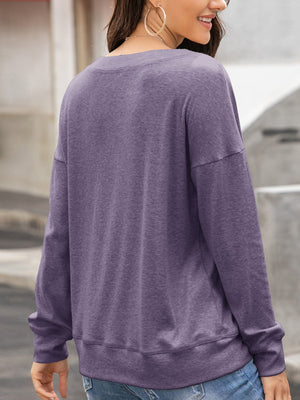 Mauve sweatshirt with drop shoulders and crew neck, casual long sleeves.