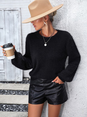 Black fluffy knit sweater with crew neck and balloon sleeves, featuring lace back detail.