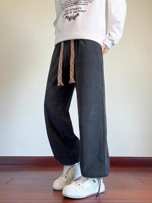 Men's gray textured wide leg sweatpants with a rainbow drawstring.