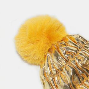 Metallic gold padded beanie with yellow faux fur pom.
