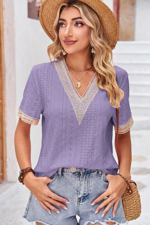 Lavender eyelet V-neck blouse with lace trim on neckline and sleeves.