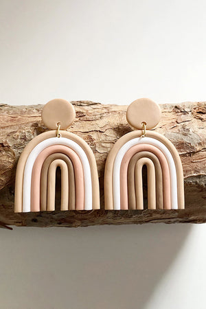 Clay rainbow arch earrings in tan, pink, white, and ivory with tan circle tops.