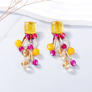 Beaded cascade statement earrings with yellow, pink, and clear beads and gold accents.