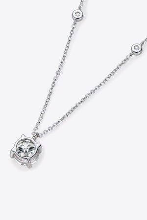 Silver moissanite solitaire necklace with a delicate chain and bezel-set stones.