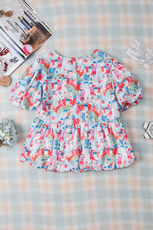 Watercolor village print peplum blouse with short puff sleeves and tiered hem.