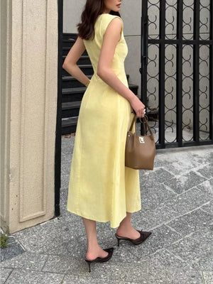 Sleeveless yellow midi dress with A-line skirt and scoop neckline.