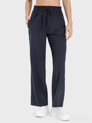 Black relaxed drape drawstring palazzo pants with pockets and wide leg.