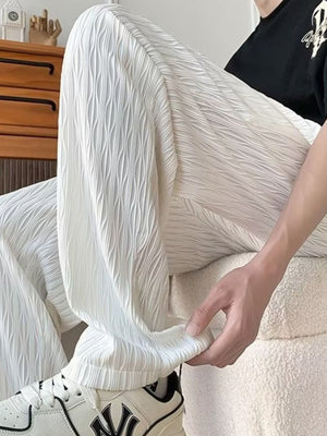 White textured wide-leg drawstring sweatpants with a crinkled pattern.